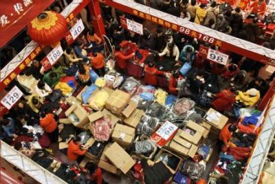 Consumers select their desired commodities in a department store during a sale promotion season before Christmas and New Year in Dalian of northeast China's Liaoning Province on Dec. 12, 2009. Emporiums in Dalian launch sales promotion that result in year-end purchase spree. (Xinhua/Wang Xizeng)