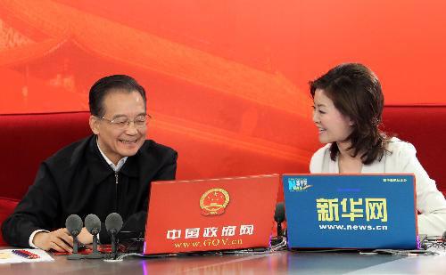 Chinese Premier Wen Jiabao (L) chats on-line with netizens at two state news portals in Beijing, capital of China, Feb. 27, 2010. The two major portals, namely www.gov.cn of the central government, and www.xinhuanet.com of Xinhua News Agency, jointly interviewed Premier Wen on Saturday with chosen questions raised by netizens. (Xinhua/Ma Zhancheng)