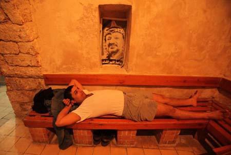 A Palestinian man relaxes at Hamam al-Samra, a traditional Turkish steam bath in Gaza City, on April 10, 2010. The hamam is one of the ancient archaeological places in the Gaza Strip built in 1,000 years ago. (Xinhua/Wissam Nassar)