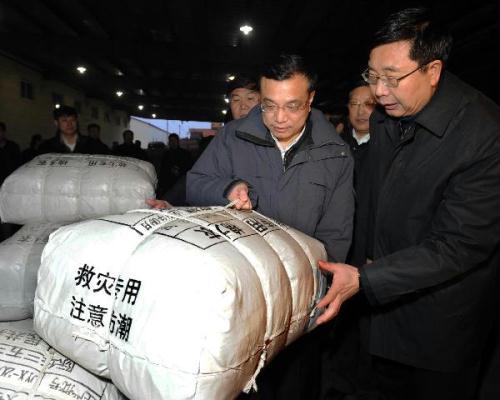 Chinese Vice Premier Li Keqiang (L, front) inspects the the urgent transportation of quake relief supplies in Shenyang, capital of northeast China's Liaoning Province, April 15, 2010. Li Keqiang on Thursday called for full commitment in the logistics work for the earthquake relief to ensure the basic livelihood of the people in quake-hit areas. (Xinhua/Li Tao)