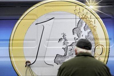 A man looks at a representation of the Slovak edition of the euro. (AFP/File/Samuel Kubani)