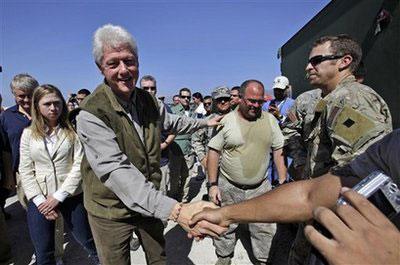 Former president and U.N. special envoy for Haiti Bill Clinton, second from left, shakes hands with soldiers of the Joint Task Force-Haiti in Port-au-Prince, Monday, Jan. 18, 2010. (AP Photo/Lynne Sladky)