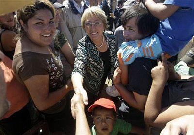 Chile's President Michelle Bachelet greets earthquake survivors in Dichato, Chile, Monday, March 8, 2010. (AP Photo/Silvia Izquierdo)