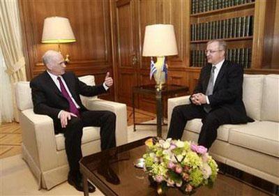 Greek Prime Minister George Papandreou (L) meets EU Economic Affairs Commissioner Olli Rehn in Athens March 1, 2010. REUTERS/John Kolesidis