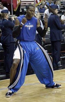 In this April 21, 2010 photo, Orlando Magic center Dwight Howard dances in front of teammates during a pre-game ritual prior to Game 2 in the first round of the NBA basketball playoffs against the Charlotte Bobcats, in Orlando, Fla. The Orlando Magic's choreographed warmup routine is a bit odd by NBA standards, and only one of the team's many playful antics.(AP Photo/John Raoux)