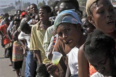 A woman gestures as she waits in line for food from the United Nations in the Cite Soleil neighborhood in Port-au-Prince, Tuesday, Jan. 19, 2010. (AP Photo/Ramon Espinosa)