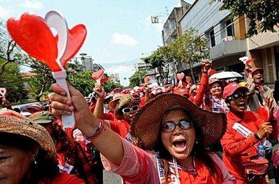 Supporters of deposed Thai premier Thaksin Shinawatra shout slogans as they parade during an anti-government protest in Bangkok. Thailand's red-shirted protesters vowed to "shut down" Bangkok with an anti-government rally Saturday, defying the government which had raised the stakes with new security measures.(AFP/Pornchai Kittiwongsakul) 