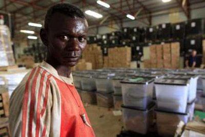 A Sudanese worker from the National Elections Commission (NEC) looks on at the central NEC ballot distribution center of Khartoum April 8, 2010. REUTERS/Ahmed Jadallah