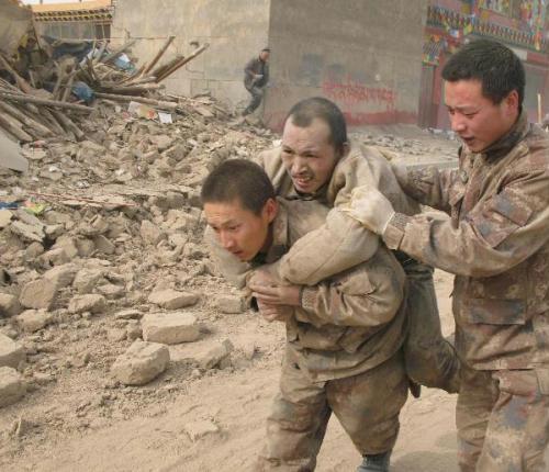 Soldiers of the Chinese People's Liberation Army rescue a survivor of quake in Yushu County, northwest China's Qinghai Province, April 14, 2010. About 400 people have died and 10,000 others were injured after a 7.1-magnitude earthquake hit Yushu early on Wednesday. (Xinhua/Wang Qiang)