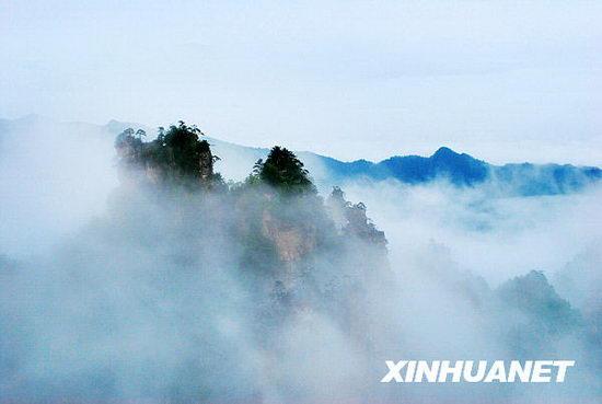 Photo taken on May 16 shows the mountains of Zhangjiajie National Forest Park, the famous tourist destination in central China's Hunan province, hidden in the misty clouds formed after a rainfall, presenting a spectacular scene as in a traditional Chinese brush painting. [Photo:Xinhuanet]