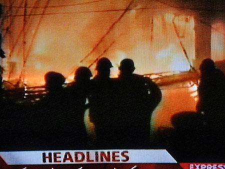 TV grab taken on Dec. 7, 2009 shows people gathering at the explosion site at the Moon Market in Lahore in east Pakistan.(Xinhua Photo)