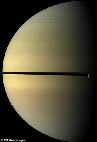 A natural colour view of Saturn and its icy moon Rhea