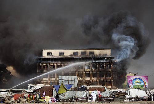 A shopping center burns in central Kabul, Afghanistan, Monday, Jan. 18, 2010.(Xinhua/Reuters Photo)