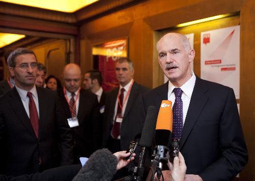 Greek Prime Minister George Papandreou speaks to media upon his arrival to a Sociallist Party Group (PSE) meeting prior to the European summit in Brussels, capital of Belgium, March 25, 2010. (Xinhua/Thierry Monasse)