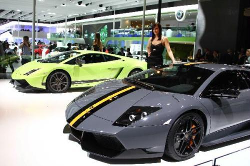A model poses beside a new Lamborghini car during the media preview at the Beiijng Auto Show on April 23, 2010. In total, nearly 2100 companies from 16 coutries and regions will exhibit during 2010 Beijing International Automotive Exhibition (Auto China 2010) . (Xinhua/Zhang Yanhui)