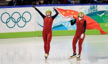 China's Wang Meng (L) celebrates with her teammate Zhou Yang after the women's 1000m final of short track speed skating at the 2010 Winter Olympic Games in Vancouver, Canada, Feb. 26, 2010. Wang Meng won the gold medal with 1 minute and 29.213 seconds. (Xinhua/Yang Lei)