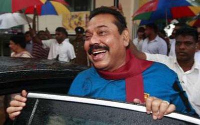 Sri Lanka's President Mahinda Rajapaksa smiles to his supporters at a polling station after casting his vote for the parliamentary elections, in the southern district of Hambantota, April 8, 2010. REUTERS/Dinuka Liyanawawtte