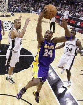 Los Angeles Lakers' Kobe Bryant (24) shoots as San Antonio Spurs' Tim Duncan, left, and Antonio McDyess (34) defend during the first quarter of an NBA basketball game Tuesday, Jan. 12, 2010, in San Antonio.(AP Photo/Eric Gay)