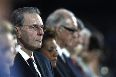 Jacques Rogge, left, President of the International Olympic Committee, stands during a moment of silence to honor the death of Georgian athlete Nodar Kumaritashvili durinthe opening ceremony of the Vancouver Winter Olympic Games in Vancouver, British Columbia, Friday February 12, 2010. (AP Photo/Jim Young, Pool)