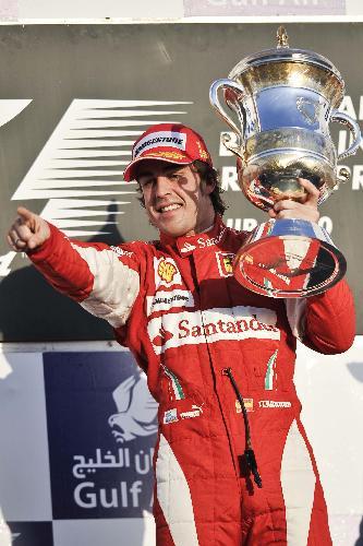 Ferrari's Spanish driver Fernando Alonso holds the trophy after winning the Bahrain F1 Grand Prix at Sakhir circuit in Manama March 14, 2010. Alonso won his Ferrari debut with 1h 39m 20.396s. (Xinhua/Zhang Ning)