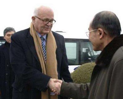 .S. envoy Stephen Bosworth (L) is greeted by a North Korean official at an airport in Pyongyang December 8, 2009. Bosworth flew from an airbase near Seoul and landed at an airport on the outskirts of Pyongyang with his delegation, a one-line dispatch by the North's official KCNA news agency said. U.S. President Barack Obama's first envoy to North Korea arrived in Pyongyang on Tuesday to try to coax the prickly state back to the nuclear talks it quit a year ago, but without offering it any new incentives.