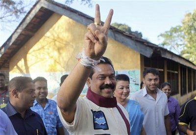 Sri Lankan President Mahinda Rajapaksa shows a victory sign after casting his vote at a polling center near Madamulana, Sri Lanka, Tuesday, Jan. 26, 2010. (AP Photo/Rafiq Maqbool)