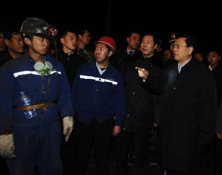 Chinese Vice Premier Zhang Dejiang (1st R, front) oversees the search and rescue operation at the site of a flooding accident of Wangjialing Coal Mine, sitting astride Xiangning County of Linfen City and Hejin City of Yuncheng City, in north China's Shanxi Province, on March 29, 2010. The number of people trapped underground after the flooding accident at Wangjialing Coal Mine was revised -- for a second time -- to 153 from 123, rescuers said late Sunday night.(Xinhua/Yan Yan) 