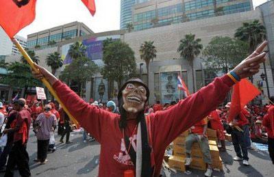 Red Shirt supporters of ousted premier Thaksin Shinawatra shout slogans during anti-government protests at a tourist hub in Bangkok on April 4, 2010. (AFP/Pornchai Kittiwongsakul)