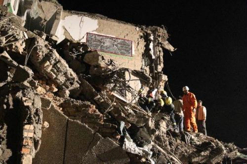 Rescuers work on the debris of a local vocational school after a quake in Yushu County, northwest China's Qinghai Province, April 14, 2010. About 589 people have died after a 7.1-magnitude earthquake hit Yushu early on Wednesday. (Xinhua/Ding Lin)