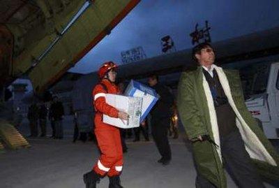 A member of the China International Search and Rescue Team carries relief materials at the Yushu airport, Qinghai Province, April 14, 2010. The death toll of China's Qinghai 7.1-magnitude earthquake rose to 589 as of early morning Thursday, according to the local quake-relief headquarters, Xinhua News Agency reported. Picture taken April 14, 2010.