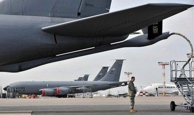 A US soldier stands near a plane bound for Afghanistan, as it fuels up at the Manas Transit Center, in Kyrgyzstan, on March 2010. The US military has suspended troop flights out of its base in Kyrgyzstan and will instead transport forces to and from Afghanistan via Kuwait, military officials said Friday.(AFP/File/Vyacheslav Oseledko) 