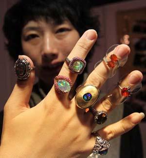 A staff worker shows rings on a jewelry exhibition held at China International Exhibition Center in Beijing, China, Nov. 5, 2009. The 5-day-long 2009 China International Jewelry Exhibition kicked off here on Thursday with about 600 companies from 15 countries and regions on shown. (Xinhua)