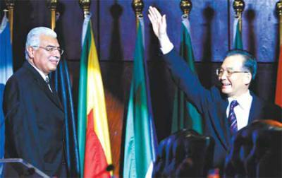 Premier Wen Jiabao greets the Fourth Ministerial Conference of the China-Africa Cooperation Forum before announcing China's commitment of $10 billion to African countries on Saturday. Egyptian Prime Minister Ahmed Nazif looks on at the summit, held in his nation's resort city of Sharm el-Sheikh. [Reuters]