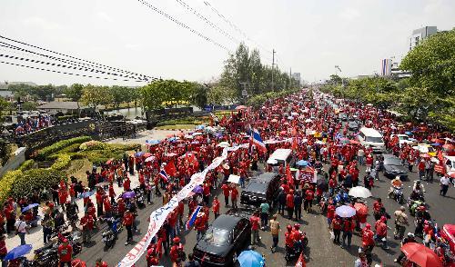 Supporters of former Thai premier Thaksin Shinawatra gather for a protest outside the base of Thai Army 11th Infantry Regiment in Bangkok, capital of Thailand, March 15, 2010. Thousands of protesters on Monday rallied outside the base where the premier Abhisit Vejjajiva had his crisis headquarters to call on him dissolve the parliament, but Abhisit refused. (Xinhua/Lui Siu Wai)