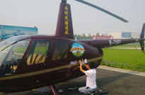 走進廣漢，工作人員在停機坪上為直升機貼我們《從農田到餐桌》系列片的標誌