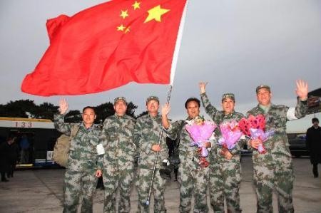 Members of the Chinese medical team pose for a group photo at Beijing Capital International Airport in Beijing, capital of China, Feb. 10, 2010. The Chinese medical team arrived in Beijing on Wednesday morning after winding up a two-week emergency aid and epidemic control mission in the quake-stricken Haiti. (Xinhua/Li Gang) 