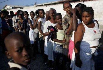 Survivors of Haiti's earthquake wait in line to get water and food from U.S. soldiers and Brazilian U.N. at the Cite Soleil in Port-au-Prince January 24, 2010. U.S. soldiers and Brazilian U.N. troops handed out food and water in one of Haiti's largest slums on Sunday amid criticism that aid was not getting to earthquake victims fast enough.REUTERS/Eliana Aponte (HAITI - Tags: DISASTER)