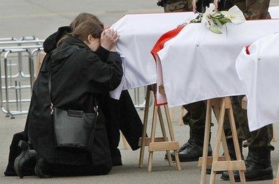 Relatives mourn at the coffins of victims of Saturday's Polish government aircraft crash near Smolensk, Russia, during a repatriation ceremony at an airport in Warsaw, Poland, Wednesday, April 14, 2010.(AP Photo/Czarek Sokolowski)