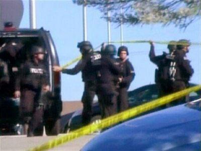 In this image made from Associated Press Television video, police respond at the scene at the U.S. Army base in Fort Hood Texas where a soldier opened fire, unleashing a stream of gunfire that left at least 12 people dead and at least 31 wounded.(AP Photo/APTN)