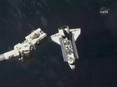 The Space Shuttle Atlantis with its open payload bay doors is seen in this view from aboard the International Space Station with the station's robotic arm in the foreground as it approaches the orbital outpost for docking in this image from NASA TV November 18, 2009.(Xinhua/Reuters photo)