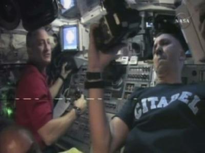 Space Shuttle Atlantis Commander Charlie Hobaugh (L) and mission specialist Randy Bresnik work on the aft flight deck of the orbiter as they approach the International Space Station for docking in this image from NASA TV November 18, 2009. (Xinhua/Reuters photo)