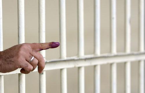 An inmate shows his ink-stained finger after voting inside a prison in Arbil, 310 km (190 miles) north of Baghdad March 4, 2010. Iraqi troops, police, prisoners and the infirm began voting on Thursday, three days ahead of a parliamentary election seen as pivotal for a divided country which U.S. troops are scheduled to leave by the end of 2011. (Xinhua/Reuters Photo)