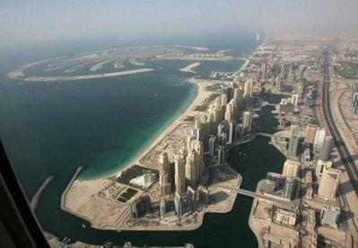 An aerial view shows the man-made Palm Jumeirah island (background) and the Madinat Jumeirah resort in the oil-rich Gulf emirate of Dubai, September 2007. Global equities slumped Thursday, with Europe down three percent after Dubai's shock call to suspend the debt of a key state company fuelled anxiety about excessive public borrowing, analysts said. (AFP/File/Karim Sahib) 