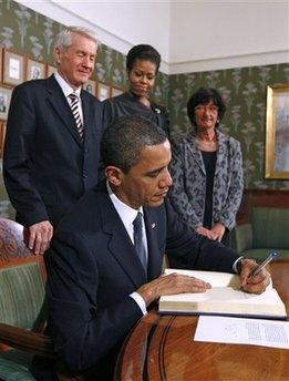 US President Barack Obama signs the Nobel guest book as first lady Michelle Obama, behind, Chairman of the Norwegian Nobel Committee, Thorbjoern Jagland, left, and committee member, Sissel Roenbeck, right, look on during a Nobel signing ceremony at the Nobel Institute in Oslo, Norway, Thursday, Dec. 10, 2009. (AP Photo/Scanpix/Terje Bendiksby, Pool)