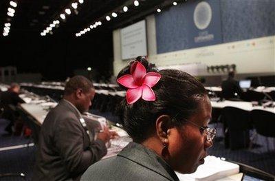 A delegate from Kiribati, right, an island nation located in the central tropical Pacific Ocean, attends a plenary session at the UN Climate summit in Copenhagen, Denmark, Friday, Dec. 11, 2009. Negotiators are working in Brussels and Copenhagen to come up with more climate change money for poor countries amid talks on a historic deal to control the world's greenhouse gases. (AP Photo/Anja Niedringhaus) 