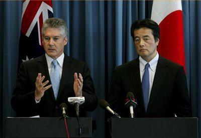 Australian Foreign Minister Stephen Smith gestures as his Japanese counterpart Katsuya Okada stands next to him at their press conference in Perth, Australia on Sunday Feb. 21, 2010. (AP Photo/Ross Swanborough)