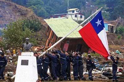 Sailors raise a Chilean flag during reconstruction efforts on Juan Fernandez island in southern Chile, Thursday, March 4, 2010. An 8.8-magnitude earthquake struck central Chile on Feb 27, causing widespread damage. (AP Photo)