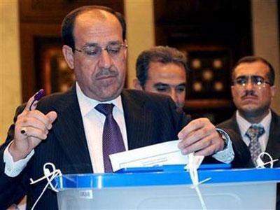 Iraqi's Prime Minister Nuri al-Maliki casts his vote inside a polling station at the green zone in Baghdad March 7, 2010. REUTERS/Iraqi Government