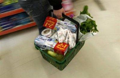 A woman carries her groceries in a basket as she shops in a supermarket on the first day of the implementation of tax increases in Athens March 15, 2010. REUTERS/Yiorgos Karahalis 