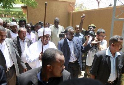 Sudanese President and presidential candidate Omar al-Bashir raises his stick as he is greeted by a supporter, after casting his vote for Sudan's first multiparty elections in decades in Khartoum, Sunday, April 11, 2010. The elections were billed as a chance to bring democracy to Sudan and start to heal a history of turmoil. (AP Photo/Amr Nabil) 